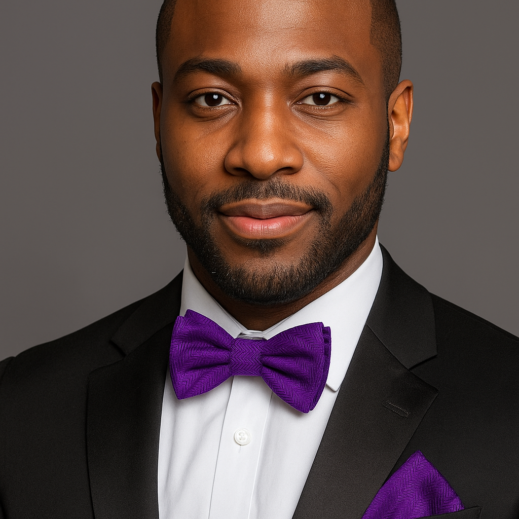 Man wearing a black suit with a purple bow tie against a gray background
