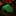 Green tie with red candy cane pattern on a wooden surface with Christmas decorations in the background