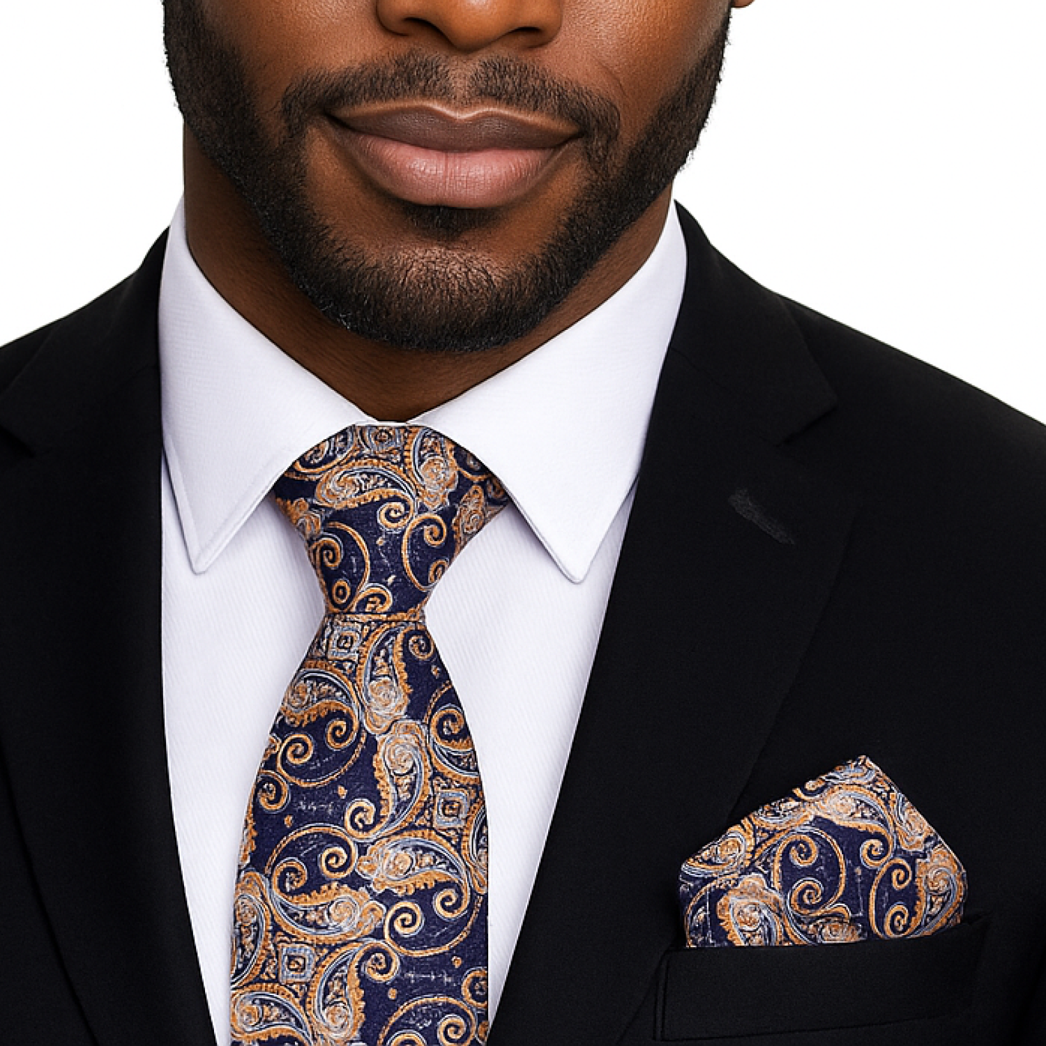 Man wearing a black suit with a patterned tie and pocket square on a white background