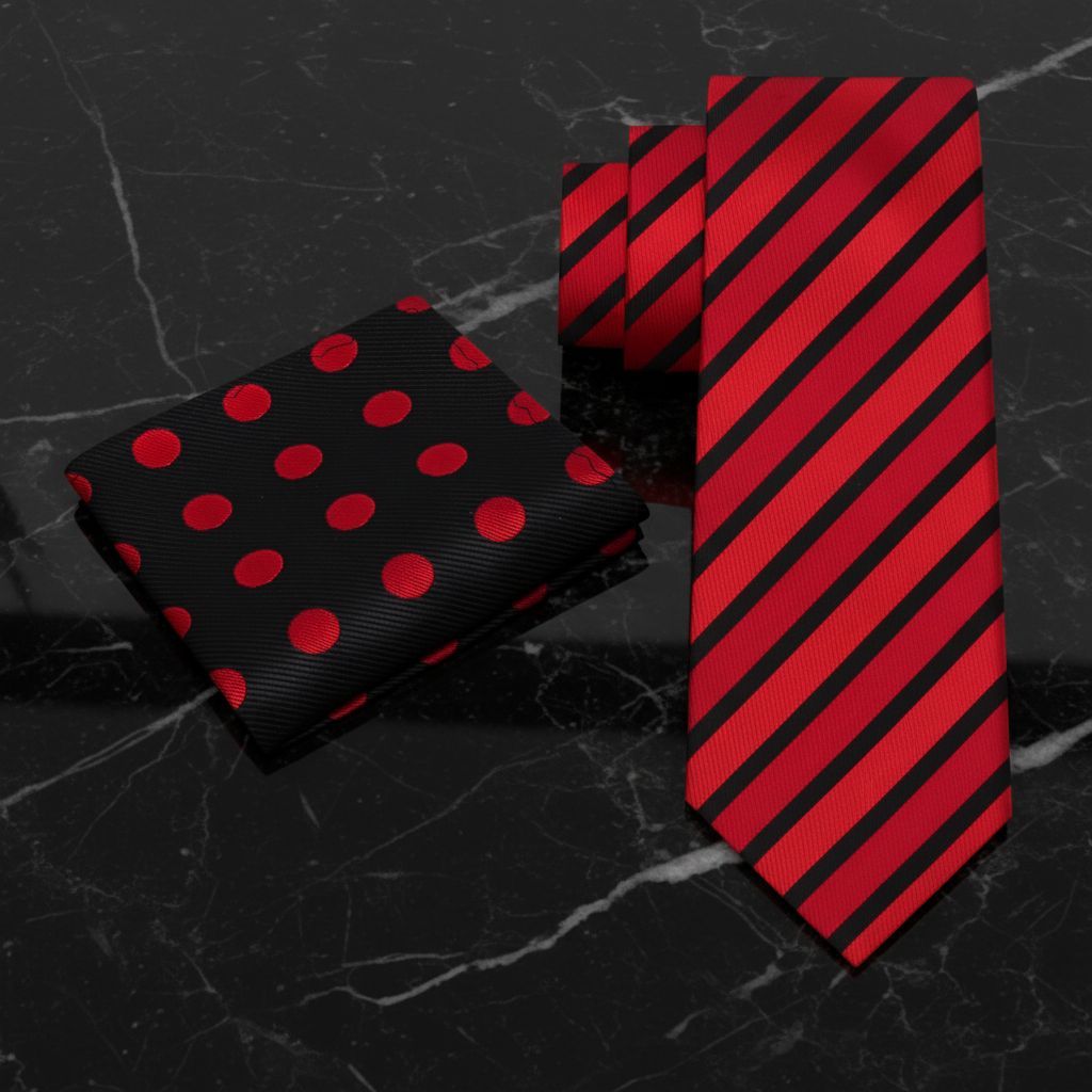 Red and black polka dot pocket square and striped tie on a white background