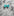An Aqua Colored Bow Tie Shaped Lapel Pin||Aqua