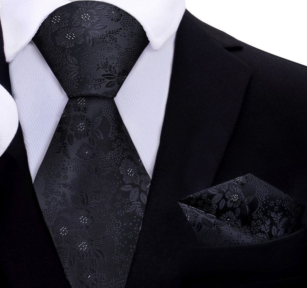 A Black With White Floral Pattern Necktie With Matching Pocket Square