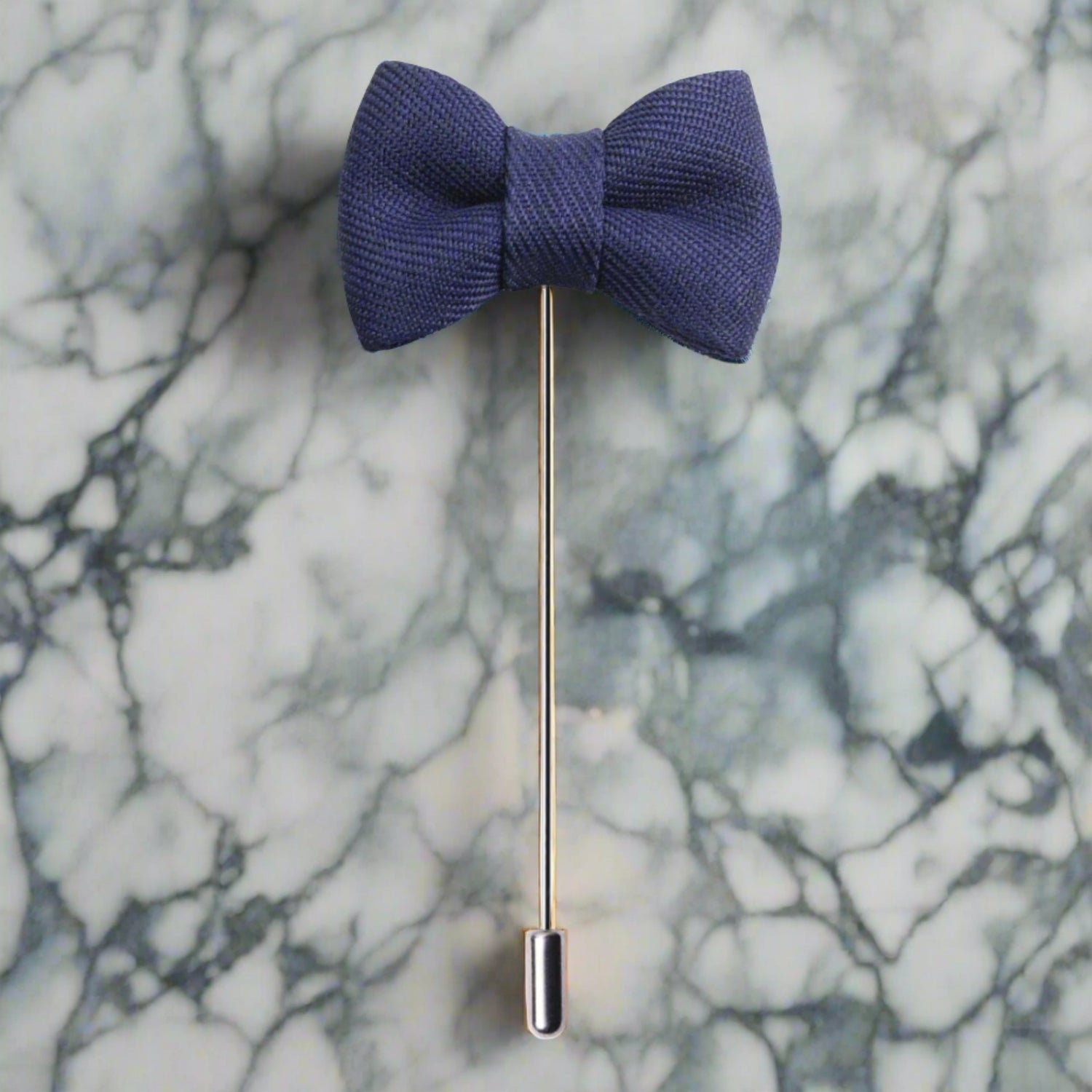 A Blue Colored Bow Tie Shaped Lapel Pin||Deep Blue