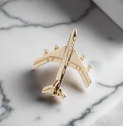 A Gold Airplane Shaped Lapel Pin||Gold