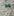 A Green Colored Bow Tie Shaped Lapel Pin||Green