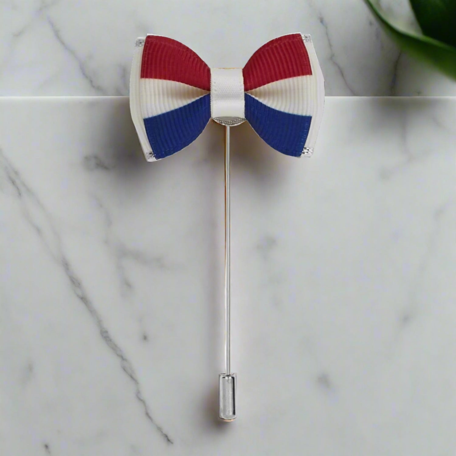 A Red, Blue, White Colored Bow Tie Shaped Lapel Pin||Red, White, Blue