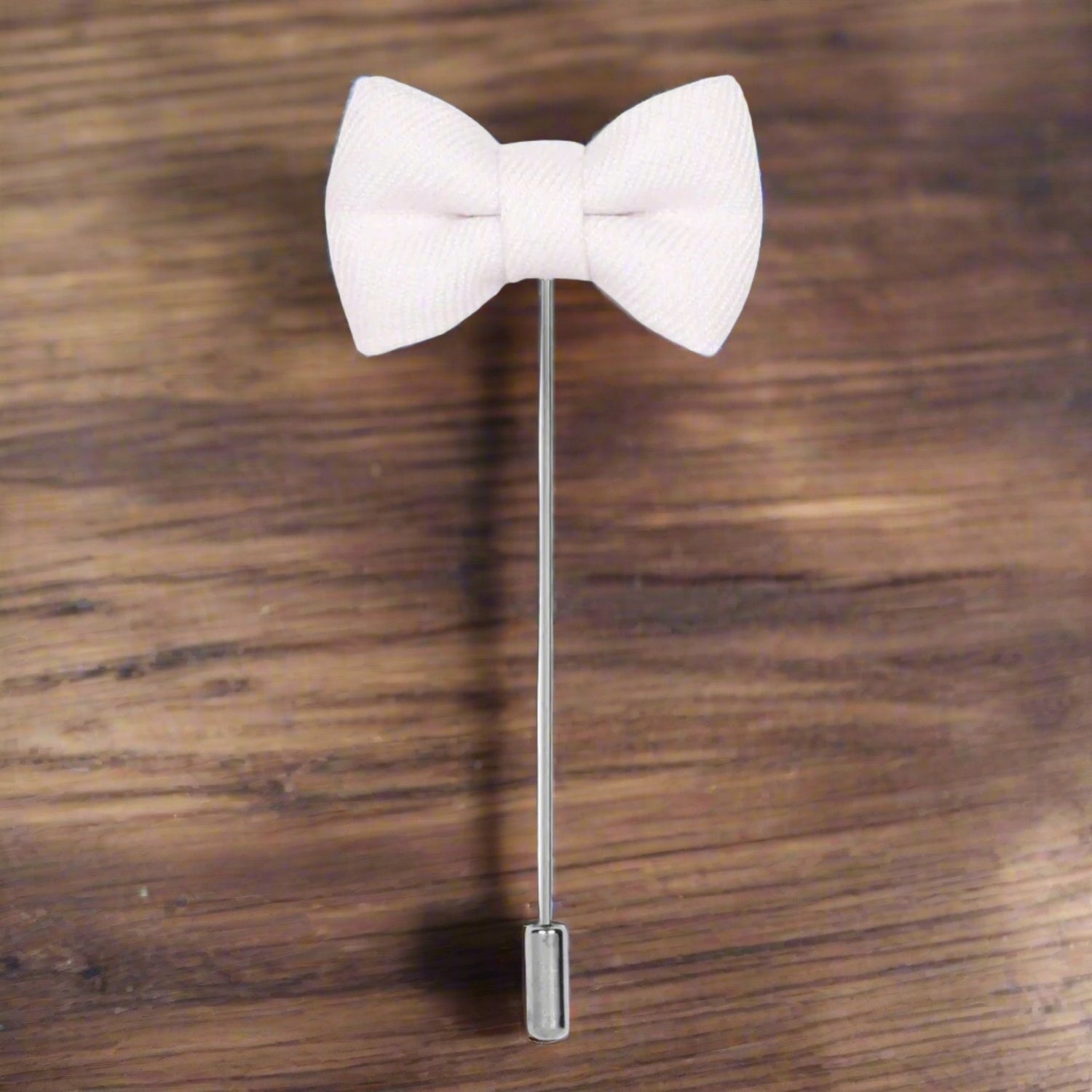 A White Colored Bow Tie Shaped Lapel Pin||White