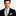 Man wearing a black suit with A Light Blue and Light Brown Abstract Shaped Pattern Necktie With