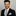 Man wearing a black suit with A Light Blue and Light Brown Abstract Shaped Pattern Necktie With Matching Square