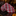 Red and white patterned tie on a dark surface with a blurred background