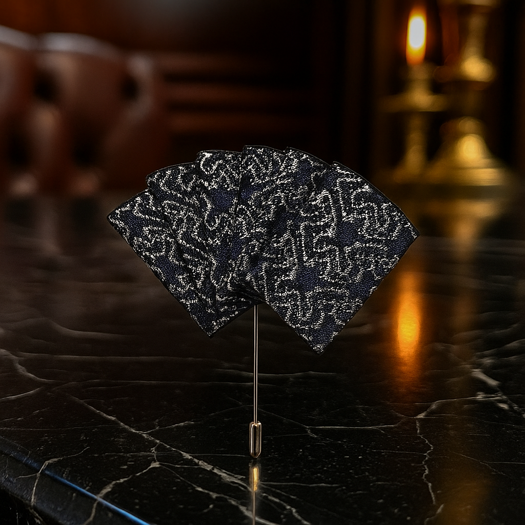 lapel pin with dark blue and silver design on a stand with a blurred background