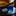 Blue tie and wallet with desert landscape design on a dark surface