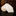 Rolled-up beige fabric on a dark surface with a blurred background