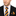 Man wearing black suit with blue and orange block stripe tie and square