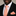 Man wearing a black suit with a white shirt, peach polka dot tie, and matching pocket square.
