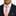 Man wearing a navy suit with a white shirt, pink polka dot tie, and matching pocket square.