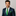 Man wearing a navy suit with an abstract green tie and pocket square on a gray background
