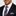 Man wearing a black suit with a purple plaid tie and matching pocket square.