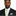 Man wearing Black Suit with Green Abstract Tie and Grey Square