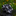 Camouflage tie on a dark surface with a blurred floral background