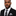 Man wearing black suit with black and grey camouflage tie and square