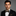 Man wearing suit with black and yellow polka dot bow tie and square