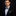 Man wearing a black suit with a An Orange, Gold, Brown Large Polka Pattern  Self Tie Bow Tie, Matching Pocket Square