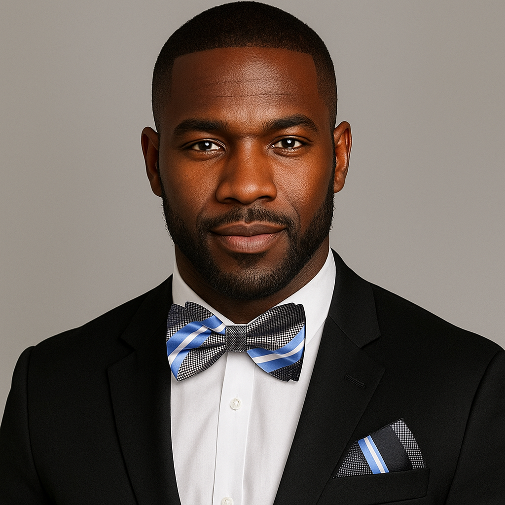 Man wearing a black suit with a blue, grey and white stripe bow tie and pocket square on a gray background