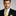 Man wearing gold geometric necktie and matching square
