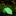 Green tie with blue polka dots on a dark surface with a blurred floral background