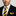 Man with black suit wearing a black and yellow block stripe tie and square