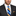 Man wearing grey suit with yellow and blue block stripe tie and square