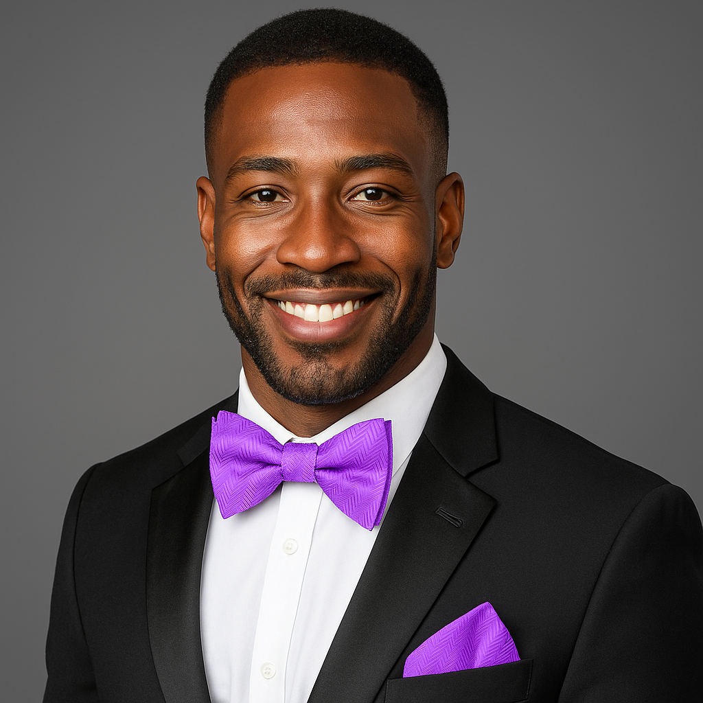 Man wearing a black suit with a purple bow tie and pocket square on a gray background