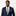 Man wearing a navy suit with a patterned tie on a plain background