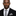 Man wearing a black suit with a gray tie and pocket square on a white background