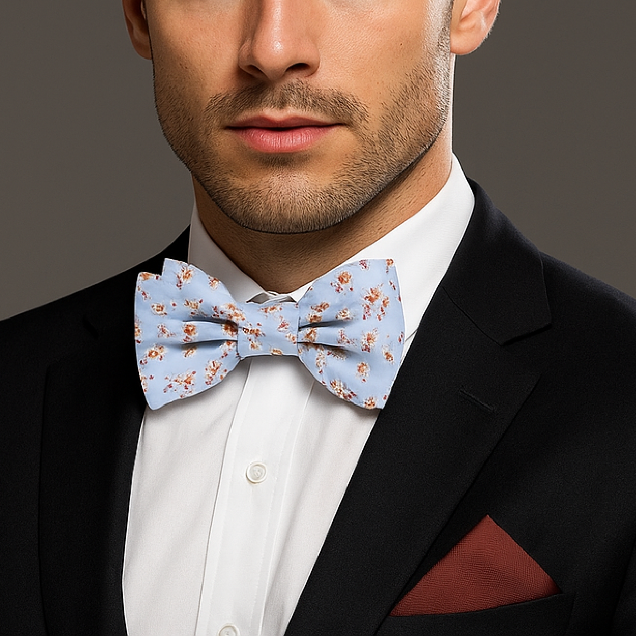 Man wearing a black suit with a Light Blue, Burgundy, Cream Magnolia Flowers Bow Tie And Accenting Pocket Square