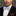 Man wearing a black suit with a Light Blue, Burgundy, Cream Magnolia Flowers Bow Tie And Accenting Pocket Square