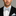 Man wearing a black suit with a white shirt and Light Blue, Burgundy, Cream Magnolia Flowers Bow Tie And Pocket Square