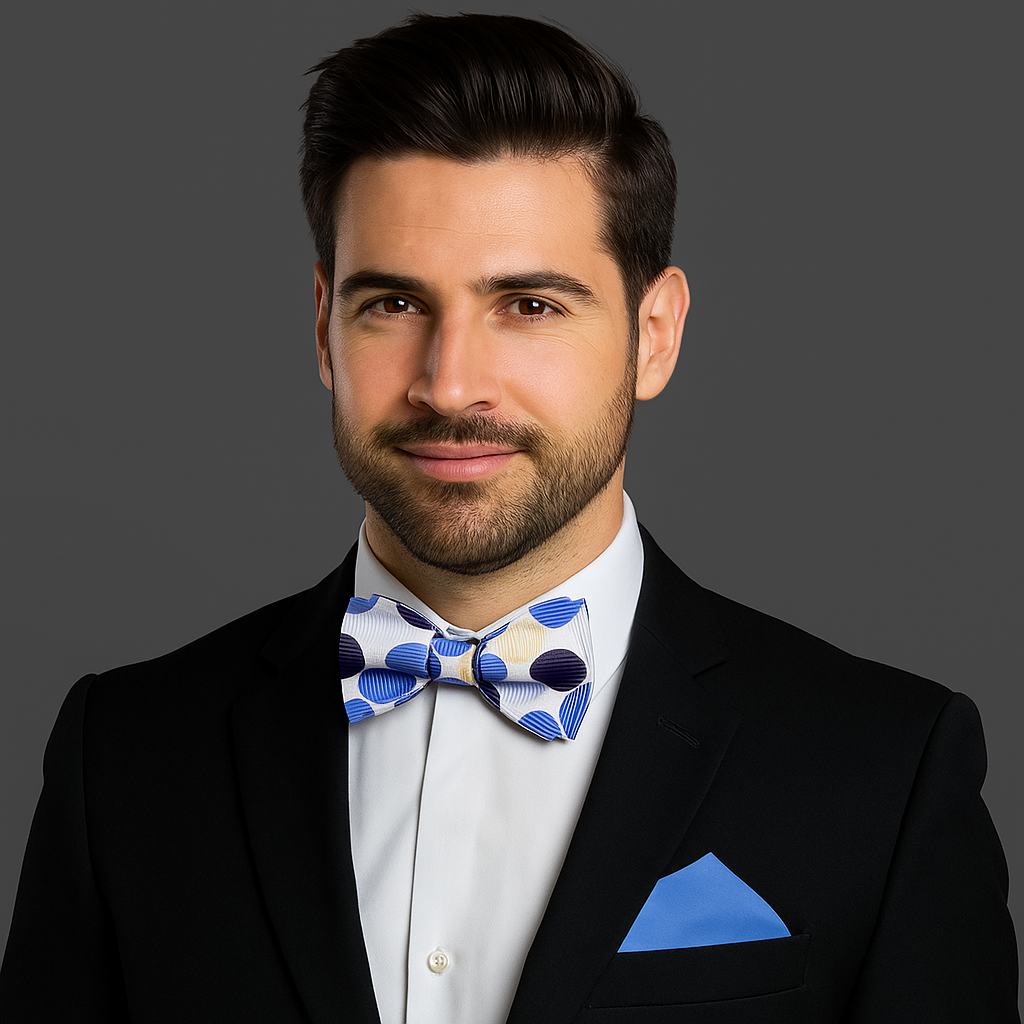 Man wearing a black suit with a White, Blue Polka Dot Bow Tie and Blue Square
