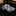 Rolled-up patterned tie on a dark surface