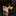 Gold American flag lapel pin on a reflective surface with a blurred background