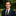 Man in a suit with an American flag pin standing outdoors
