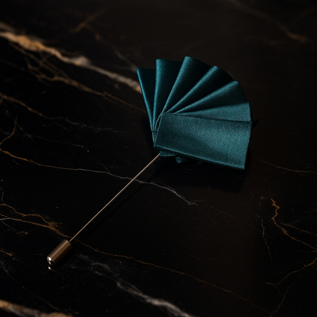 Teal lapel pin on a dark marble surface