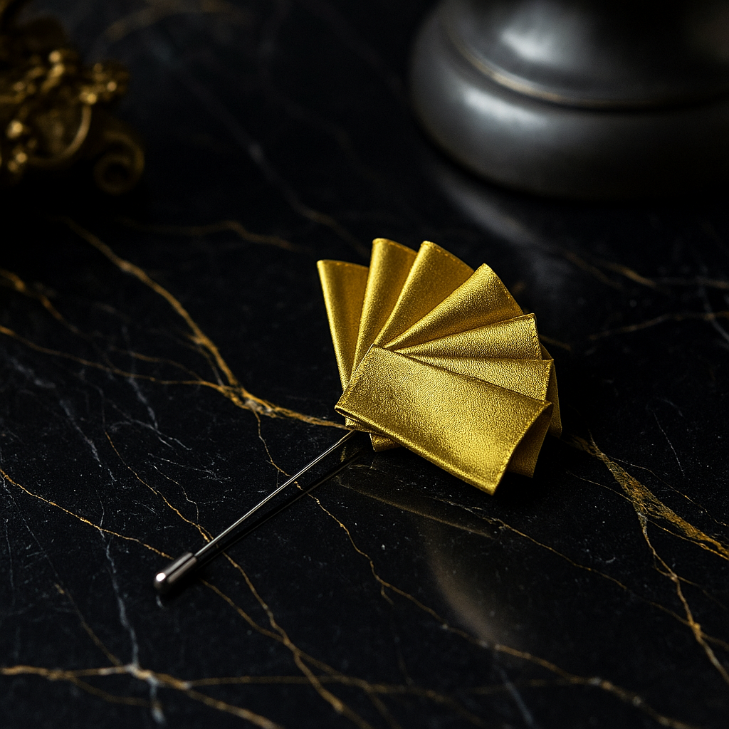 Gold fan-shaped brooch on a dark leafy background