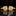 Gold cufflinks with pink gemstones on a reflective black surface