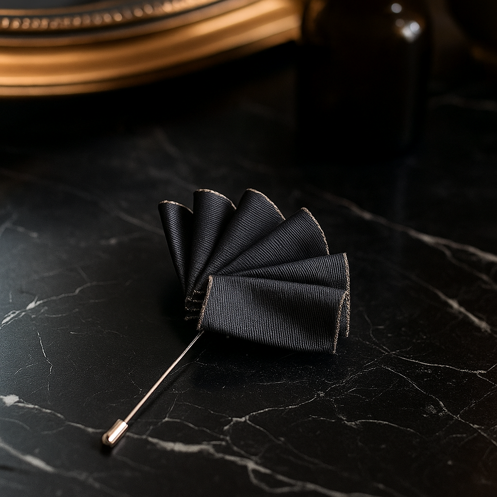Black bow tie lapel pin on a dark textured surface