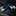 Pair of blue leather cufflinks with silver clasps on a dark marble surface