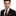Man wearing black and orange floral tie and square