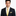 Man wearing a black suit with a yellow tie and pocket square on a white background