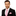 Man wearing a black suit with a pink tie and pocket square on a white background